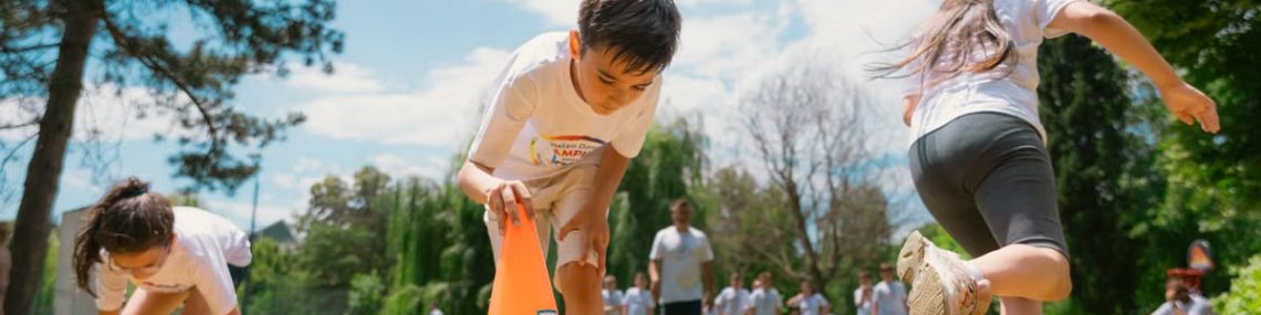 Children playing an obstacle course in a park on a sunny day, promoting fun and physical fitness.